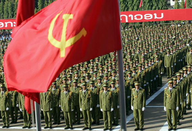 VIENTIANE, LAO PEOPLE'S DEMOCRATIC REPUBLIC: Lao soldiers stand at attention as they listen to the speech of Laos' People's Revolutionary Party Chairman Khamtay Siphandone during the official celebrations, 02 December 2005 in Vientiane to mark the 30th anniversary of the communist regim in landlocked Laos, one of Asia's poorest countries. AFP PHOTO/HOANG DINH Nam (Photo credit should read HOANG DINH NAM/AFP/Getty Images)